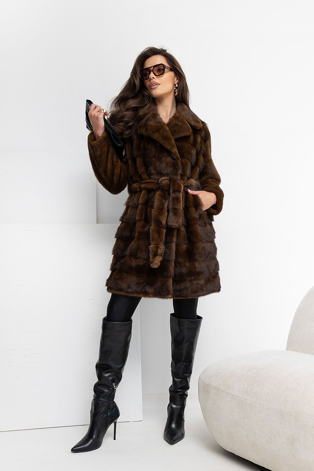 Elegant fur coat with a belt and a comfortable fastening