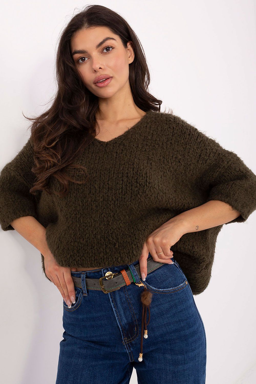 Green sweater with decorative threads and a round neckline
