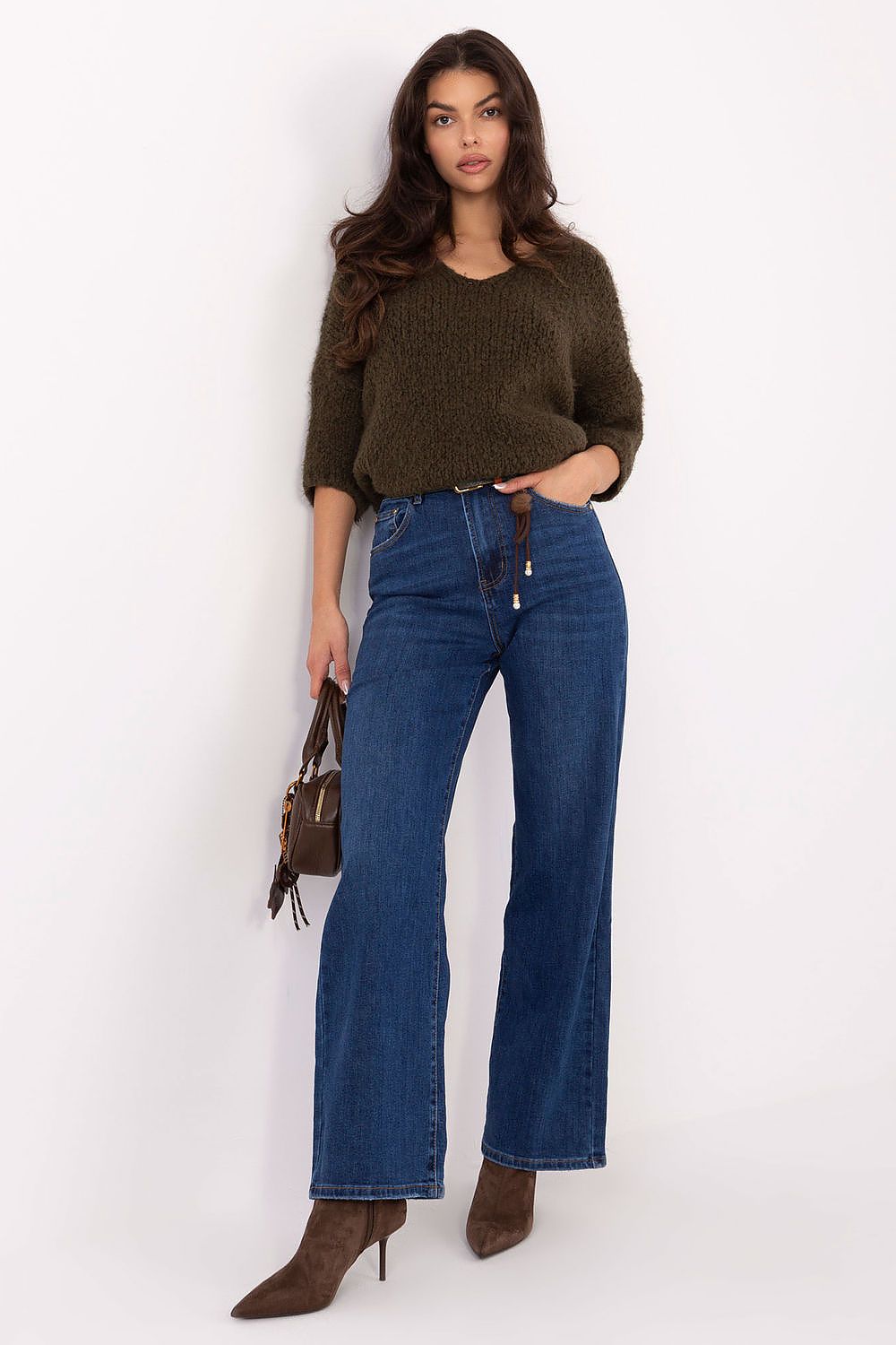 Green sweater with decorative threads and a round neckline